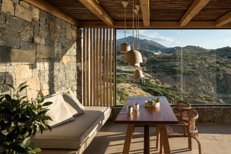 Wooden dining table on terrace with mountain view