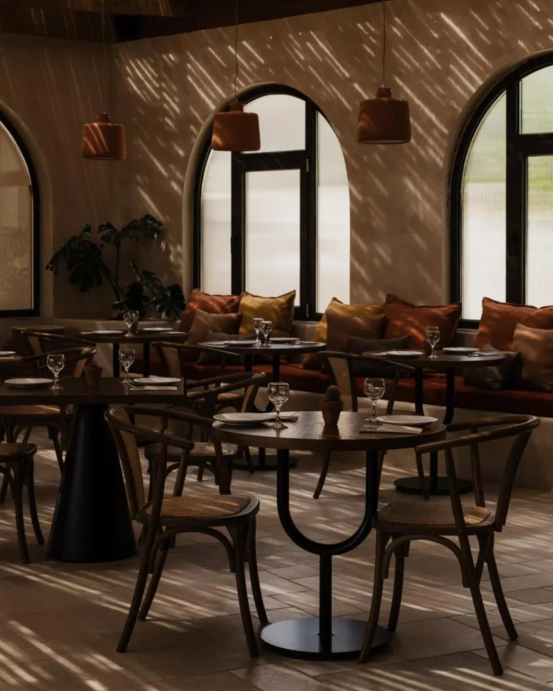 Restaurant dining room with arched windows and light patterns