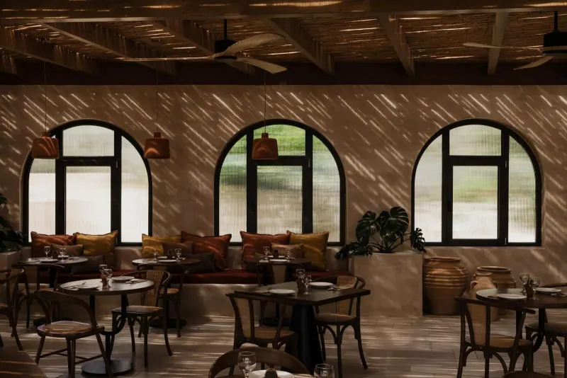 Restaurant interior with woven ceiling and arched windows
