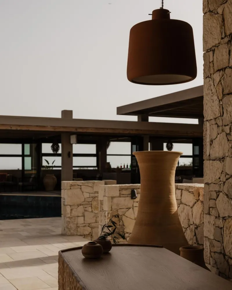 Poolside terrace view with pendant lamp and vase