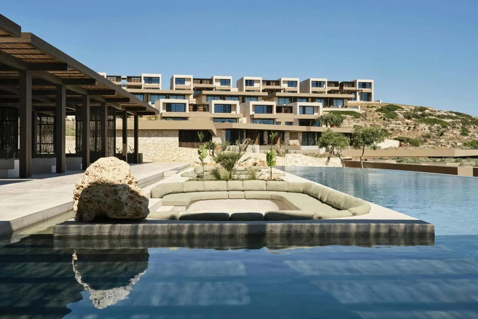 Resort exterior with tiered rooms and central pool