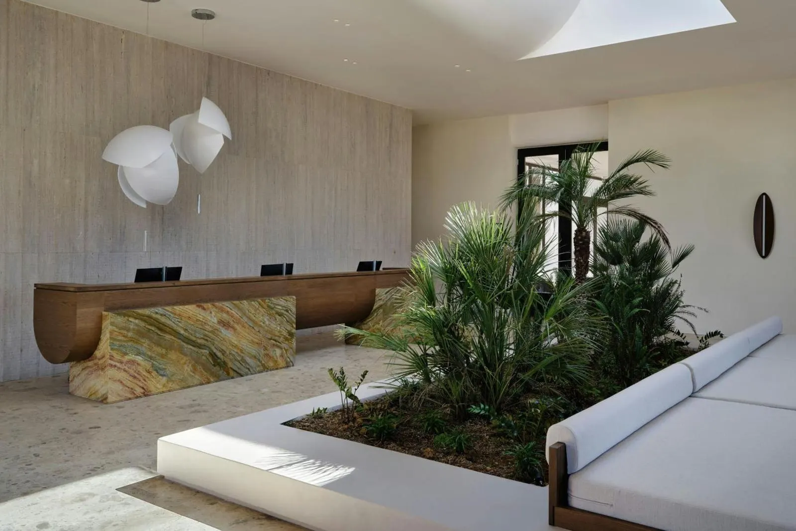 Modern lobby lounge with sculptural art and plants