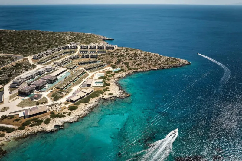 Aerial view of resort peninsula along turquoise coastline