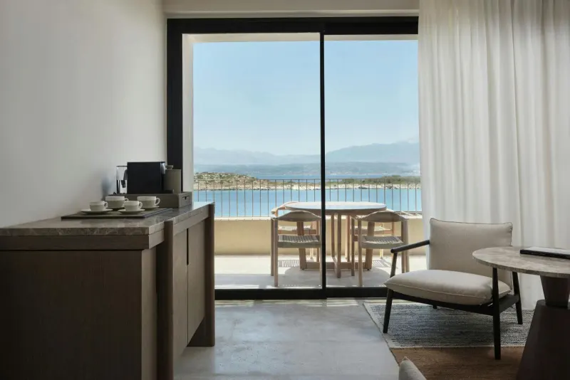 Room with balcony seating and sea view