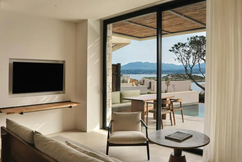 Living room with TV and terrace pool view