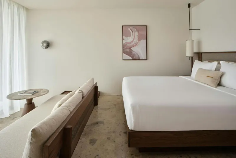 Bedroom with abstract art and wooden bed frame