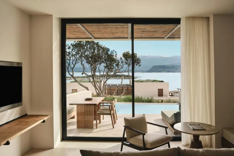 Living space opening to terrace with pool and sea view